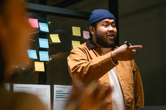 An asian man facilitating an engaging workshop.