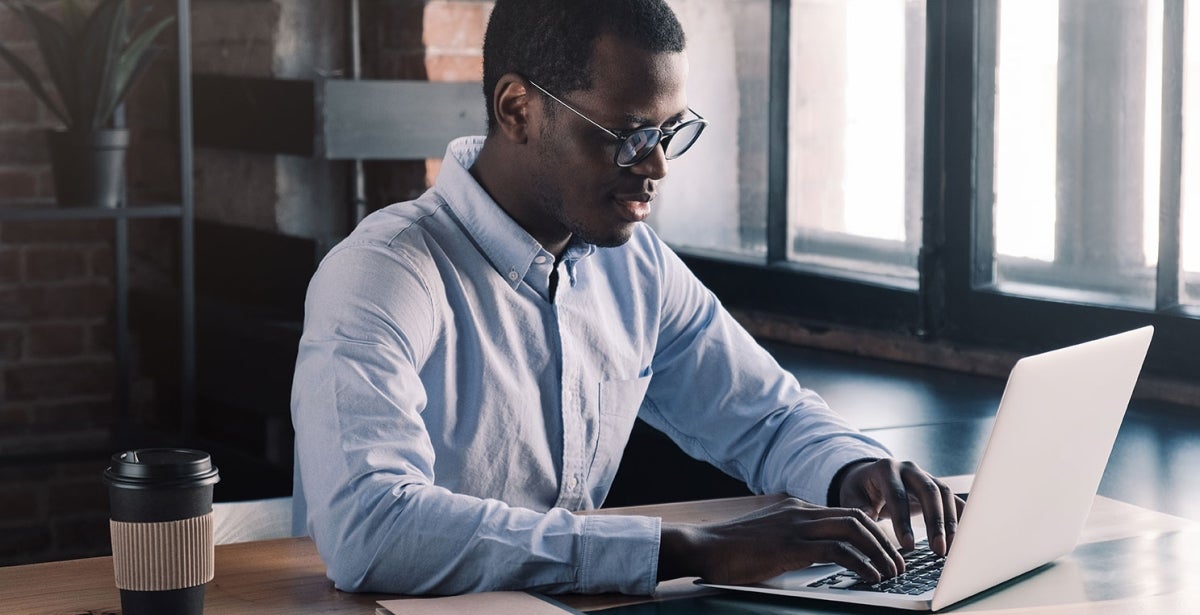 A finance expert working on laptop.