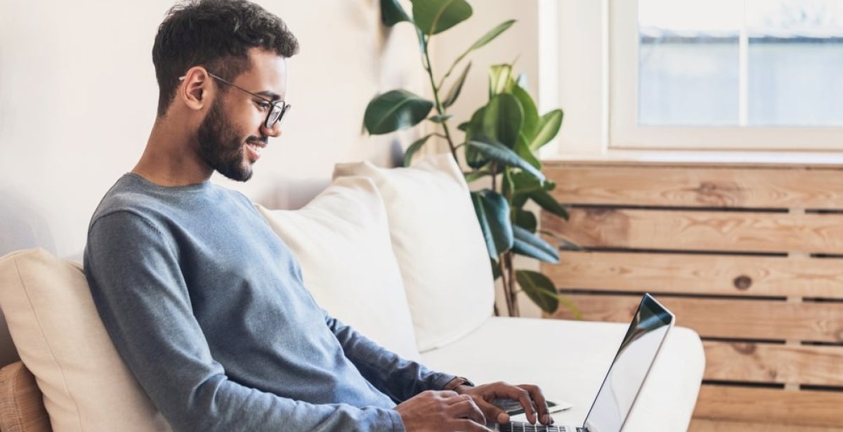 A cyber security professional working on a laptop