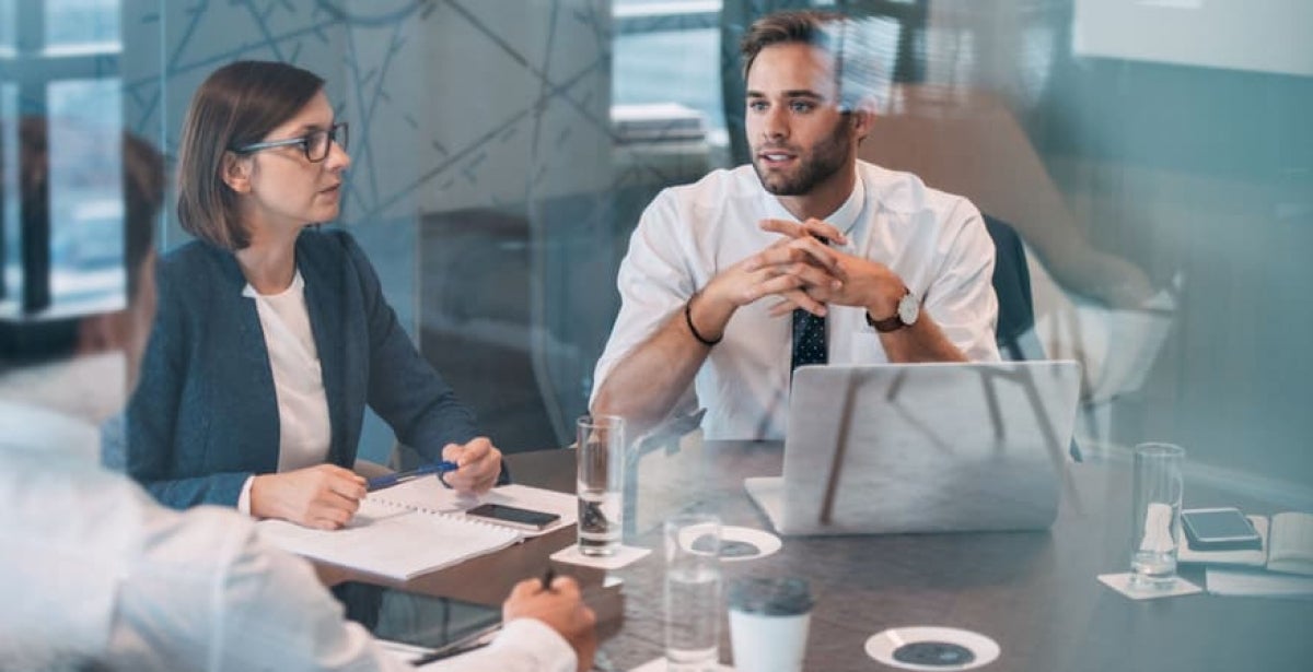 A data analyst advising his colleagues at an executive board meeting. 