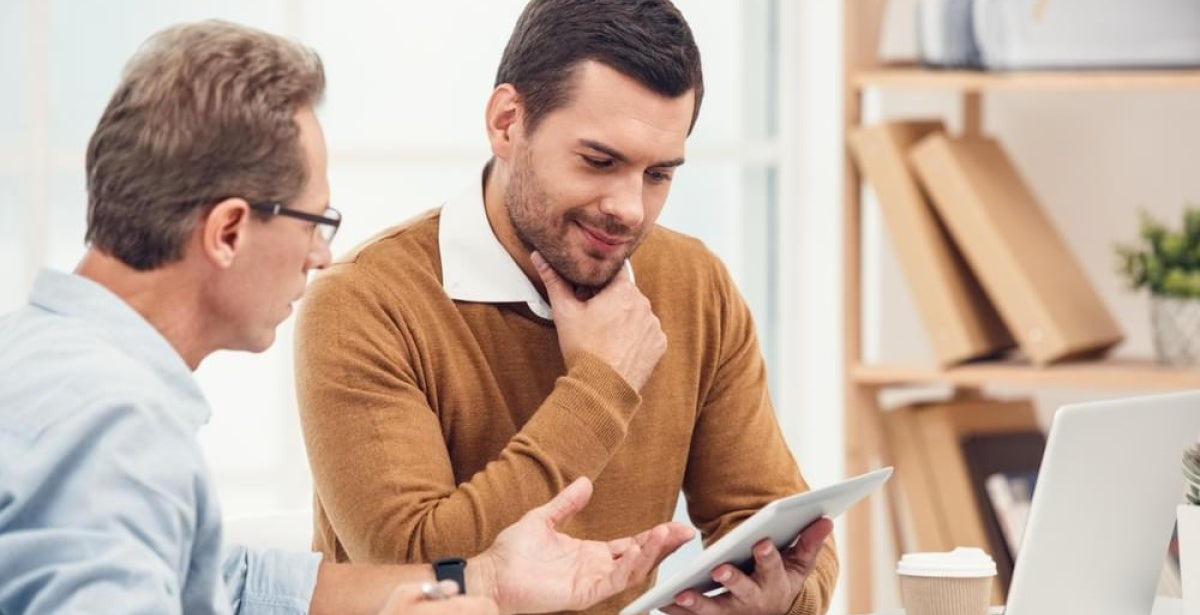 Student looking at university rankings on a tab.