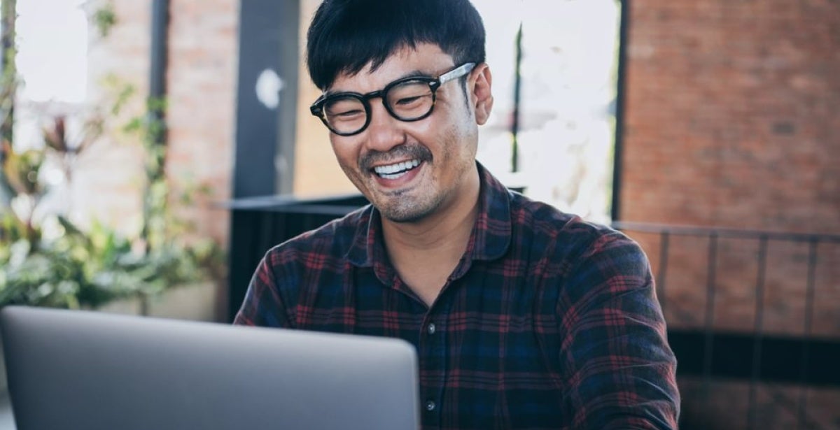 A finance expert working happily on his laptop