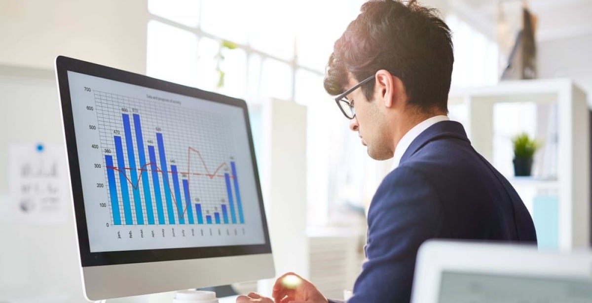 A fintech expert working at his computer