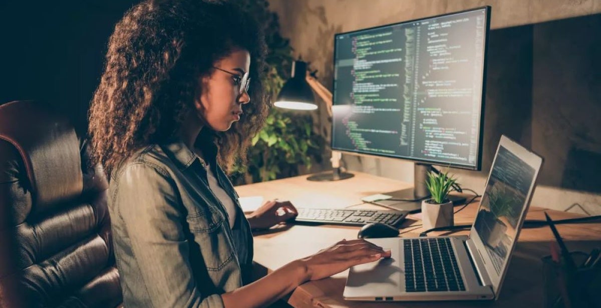 A female cyber security expert working on her laptop