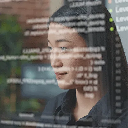 Professional focused on a computer screen displaying technical information.