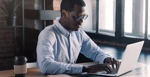 A finance expert working on laptop