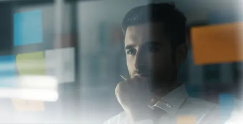 Man staring and pondering at a screen