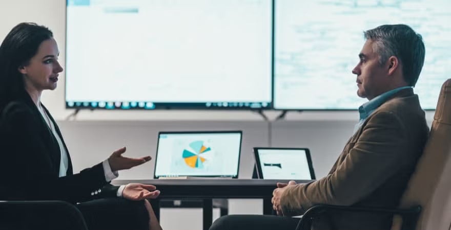 A female data analyst presenting some customer insights findings to a CEO